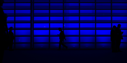people walking in dark blue office data privacy