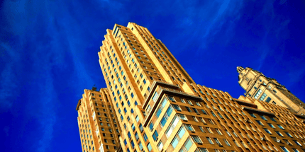 yellow skyscraper building and blue sky