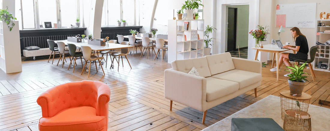 Woman working on laptop in coworking flex space