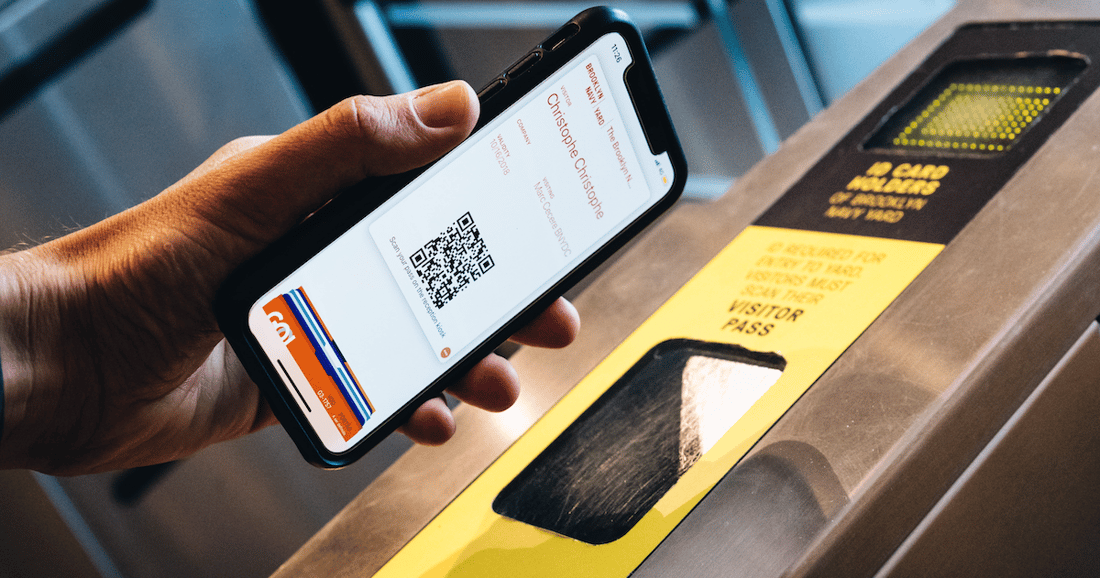 person scanning QR code at turnstile